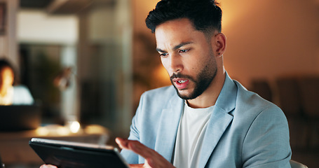 Image showing Confident business planning a marketing strategy on a digital tablet while working in a modern office. Young professional using an online app to manage time and balance his tasks, a list for success