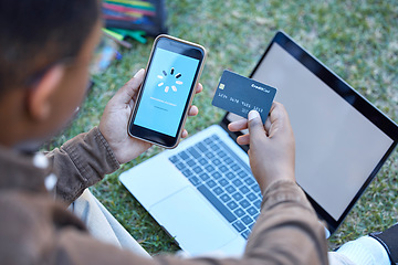 Image showing Credit card, phone banking app and loading on a mobile website payment with laptop mockup screen. Online shopping, ecommerce and 5g connectivity of a customer doing a internet sale outdoor on grass