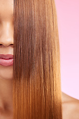 Image showing Beauty, hair and half face of black woman isolated in studio with pink background for salon advertising. Haircare, straightener and Brazilian hairstyle on model for luxury growth product promotion.