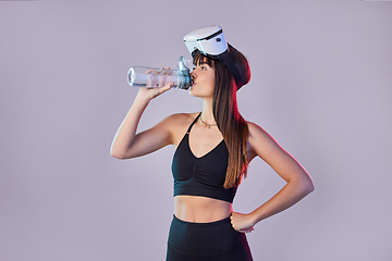 Image showing Fitness woman, drinking water and VR for exercise, training or simulation against a studio background. Thirsty female with bottle for refreshment after intense virtual reality workout on mockup