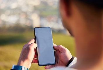 Image showing Man, hands and phone with mockup screen in social media, chatting or texting for travel, journey or trip in nature. Hand of male holding smartphone display with 5G connection for GPS in the outdoors