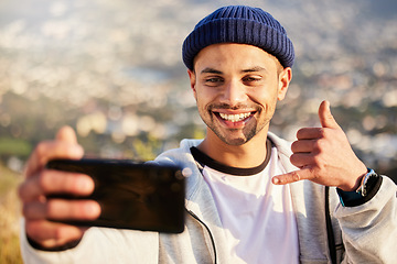 Image showing Fitness, hiking and man taking a selfie on the mountain after walking for a exercise in nature. Sports, health and young male hiker taking a picture while trekking outdoor for a cardio workout.