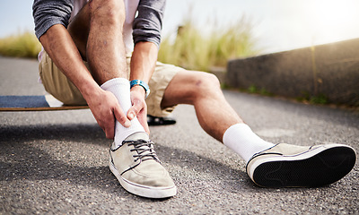 Image showing Fitness, athlete and man with ankle injury, pain or accident while skateboarding in the street. Sports, exercise and male skateboarder with muscle sprain, medical emergency or injured leg in the road