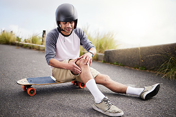 Image showing Injury, man and knee pain after skateboarding fall, sports practice and learning to skate. Active, bad and skateboarder with a sprain, broken bone or holding a painful leg in the street while skating