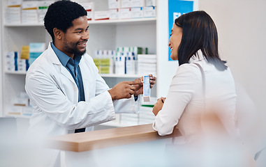 Image showing Pharmacy, counter and pharmacist with medicine for customer for wellness, drugs and medical prescription. Healthcare, clinic and black man help, service and smile at client with medication products