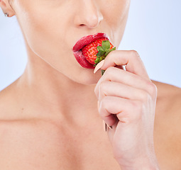 Image showing Closeup, strawberry and woman with skincare, healthy lifestyle and girl against a blue studio background. Zoom, female and lady with red fruit, berry and cosmetics for wellness, diet and nutrition