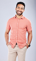 Image showing Fashion, happy and portrait of a man in a studio with a casual, trendy and cool outfit. Happiness, smile and full length of a male model from Puerto Rico with style posing by a gray background.