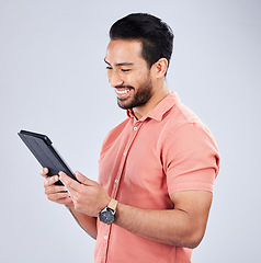 Image showing Asian man, tablet or browsing on isolated studio background on internet sales, promotion or ecommerce store deals. Smile, happy or relax customer on technology, retail e commerce or online shopping