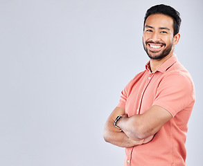 Image showing Portrait, mock up and a man in studio, crossed arms standing on a gray background for branding or product placement. Marketing, advertising and mockup with a handsome young male posing on blank space