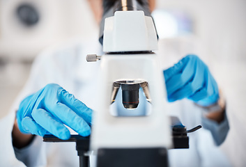 Image showing Microscope, medical science and hands in a laboratory for research, analysis and study. Scientist person in lab for futuristic development, innovation and biotechnology with dna or bacteria particle