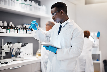 Image showing Science, research and black man test tube and tablet for medical analysis and innovation in laboratory. Pharmaceutical analytics, medicine study and scientist in South Africa checking vaccine results