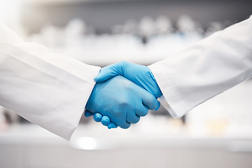 Image showing Doctor, handshake and gloves for healthcare, partnership or trust for collaboration, unity or lab support at. Team of medical experts shaking hands in teamwork for agreement or research success