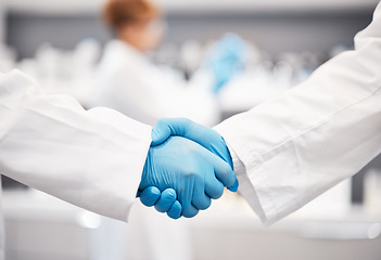 Image showing Doctor, shaking hands and gloves for safety in healthcare, partnership or trust for collaboration, unity or support at lab. Team of medical experts handshake in teamwork for agreement or success