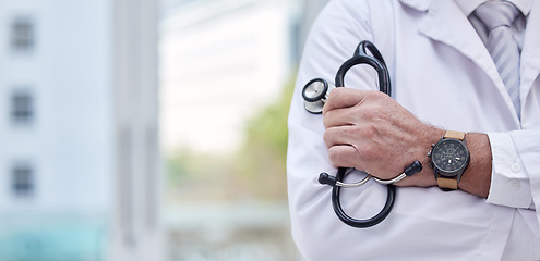 Image showing Doctor, arms crossed or medical stethoscope in hospital mockup trust, healthcare wellness or life insurance support. Zoom, man or confident cardiology equipment in hands for worker on clinic mock up