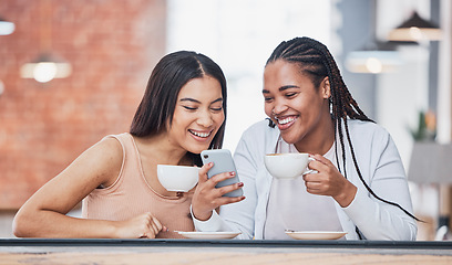 Image showing Women friends, coffee shop and smartphone with meme, happy and laugh at comic smile for social network. Gen z black woman, phone and relax in cafe with blog, funny video or reading on app for chat