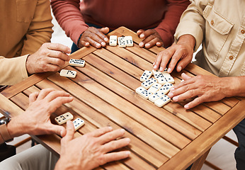 Image showing Hands, dominoes and friends in board games on wooden table for fun activity, social bonding or gathering. Hand of domino players with rectangle number blocks playing in group for entertainment