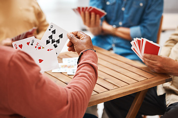 Image showing Senior friends, hands or playing card games on wooden table in fun activity, social bonding or gathering. Group of elderly men having fun with cards for poker game enjoying play time together at home