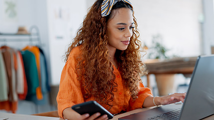 Image showing Business woman, smartphone and laptop for budget, finances and online marketing in shop, happy and smile. Black female, entrepreneur and digital device to check inventory, browse internet and chat.