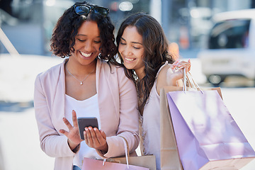 Image showing Black woman, phone and online shopping with friends, street and bag with smile, meme or excited. Women, smartphone and texting in metro on social media app with happiness in summer with e-commerce ui