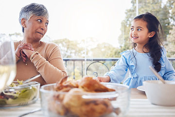 Image showing Food, family and grandmother with girl a table for lunch, party or social gathering on a patio. Love, dinner and senior woman looking at grandchild while sharing a meal, happy and smile outdoors