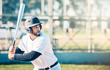 Image showing Sports, baseball and man in action with bat on field ready to hit ball in game, practice and competition. Fitness, motivation and male athlete outdoors for exercise, training and workout for match