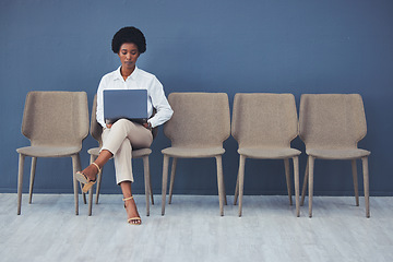 Image showing Black woman, laptop and focus for interview on chair with email, waiting and ready for job opportunity. Young african businesswoman, recruitment and mockup with computer for typing, research and goal