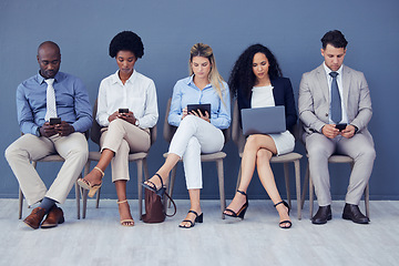 Image showing HR, technology and business people waiting in line for an interview during the recruitment process. Resume, diversity or hiring with a man and woman employee group sitting in a human resources row