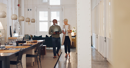 Image showing Elderly, creative business people and tablet walking in the office in project discussion, planning or corporate startup. Senior man and woman having a walk and talking in conference or boardroom