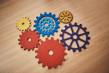 Image showing Mechanism, brainstorming and connection with cog gear on table for teamwork, solidarity and development. Collaboration, strategy and solution with machine parts for structure, cooperation or progress