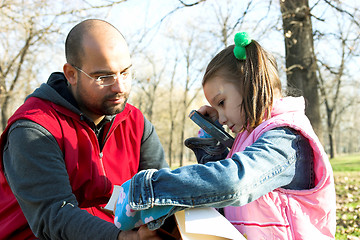 Image showing child and father reading the book