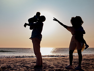 Image showing Sunset silhouette, beach and family play, bond or enjoy quality time together for vacation love, holiday peace or freedom. Ocean sea water, nature travel shadow or fun nature people in Toronto Canada