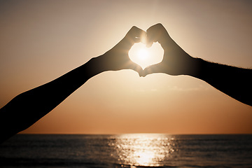 Image showing Beach sunset silhouette, couple and heart hand sign for travel freedom, outdoor peace or nature beauty. Wellness, sky flare and emoji gesture for ocean love, sun light or sea water on summer holiday