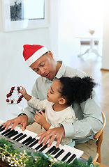 Image showing Father, girl and teaching piano at Christmas with care, happiness or love with bonding, singing and house. Man, child and music keyboard for education, learning or holiday cheer in black family home
