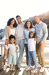 Image showing Happy, smile and portrait of a big family outside on the balcony of their modern house. Happiness, excited and girl children siblings standing with their parents and grandparents outdoor at the home.