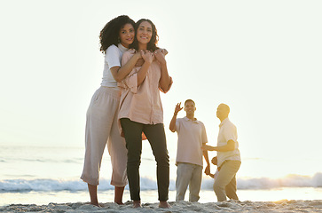 Image showing Embrace, portrait and mother and daughter at the beach for vacation, family walk and bonding. Sunset, love and elderly mom and woman hugging with affection while walking at ocean in summer for peace