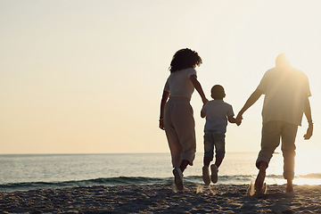 Image showing Silhouette, beach and a family with kids by the ocean, holding hands in nature at sunset from the back. Summer, travel or mockup with a mother, father and child having fun while bonding at the sea