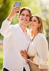 Image showing Couple, selfie and happiness outdoor for love, care and smile together in nature garden for social media. Happy man, young woman and take photograph in park for holiday, date and relax in summer