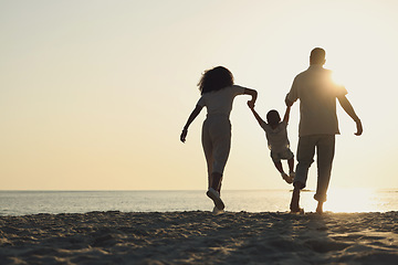 Image showing Silhouette, mockup and a family on a beach, playing while having fun together by the ocean or sea. Kids, travel or love with a mother, father and child on the sand at sunset to play while bonding