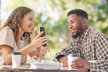 Image showing Coffee, black couple and phone outdoor while talking and bonding on date at table. Man and woman at cafe with smartphone and a drink or tea to relax with mobile app, social media or online post