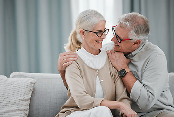 Image showing Love, hug and mockup with a senior couple sitting on a sofa in the living room of their home together. Romance, affection or mock up with a mature man and woman hugging or bonding in their house