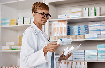 Image showing Pharmacist, medicine and healthcare with a woman working and reading information on pills box. Black person in a pharmacy, clinic or shop for pharmaceutical, medical and health service or inventory