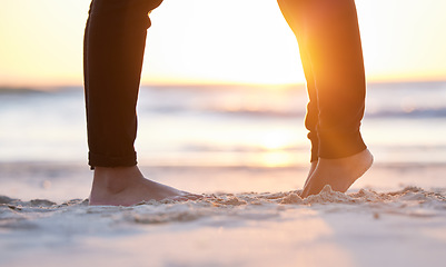 Image showing Couple at beach, legs and feet in sand with sunrise, love and commitment in relationship with travel. Adventure together, trust and respect, care in partnership and people, ocean with holiday in Bali