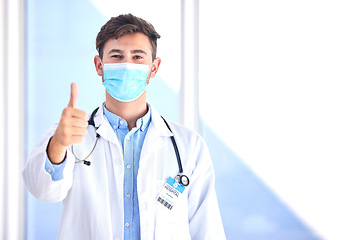 Image showing Portrait, doctor and man with thumbs up, mask and success for cure, diagnosis and safety compliance. Face cover, male and medical professional with gesture for ok, emoji and healthcare with mockup