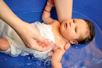 Image showing A baby girl in a bathtub