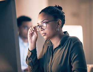 Image showing Serious black woman, computer and reading email, code or corporate information at night by the office. African American female employee focusing with glasses on PC working late at the workplace