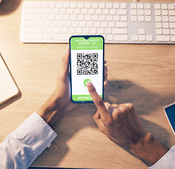 Image showing Hands, phone and QR code of covid vaccination for online passport, travel or business trip at night by office desk. Hand of employee holding smartphone with approved verification for traveling