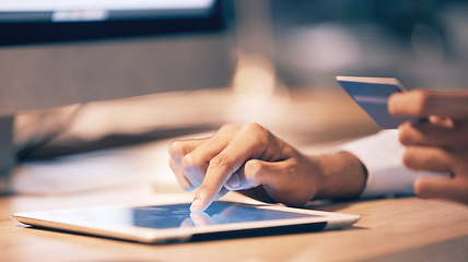 Image showing Hands, tablet and credit card for ecommerce, online shopping or banking at night on office desk. Hand of employee shopper typing on touchscreen for internet purchase, bank app or transaction on table