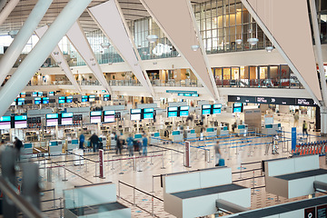Image showing Busy, moving and people in an airport for travel, check in and departure. Building, speed and crowd walking, moving and arriving or leaving for a trip, holiday or traveling for work or vacation