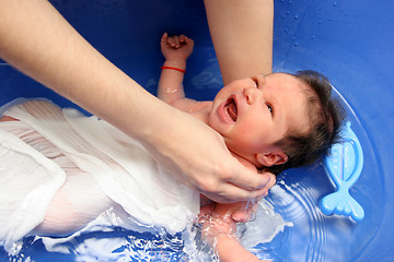 Image showing A baby girl in a bathtub