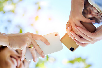 Image showing Hands, bottom view or girl friends with phone in park with smile for online meme, reading comic blog or social media. Typing or women on 5g smartphone for networking, sharing or transfer in outdoors